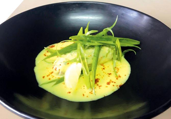 Poached snapper paupiette with lemon turmeric veloute and spring greens