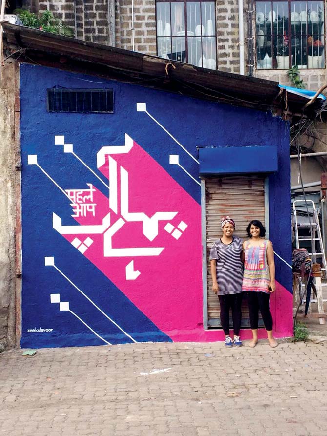 Artist Zeenat Kulavoor and Madhuvanthi Mohan of Design Fabric stand by the mural created in Shakti Mills Compound