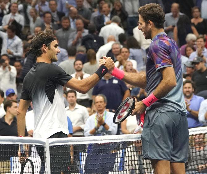Juan Martin del Potro (R) of Argentina and Roger Federer of Switzerland meet at the net after their 2017 US Open Men