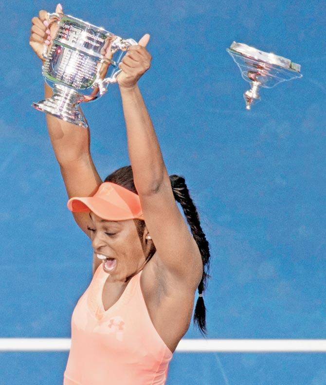 Sloane Stephens reacts as the lid of the championship trophy falls off after the women