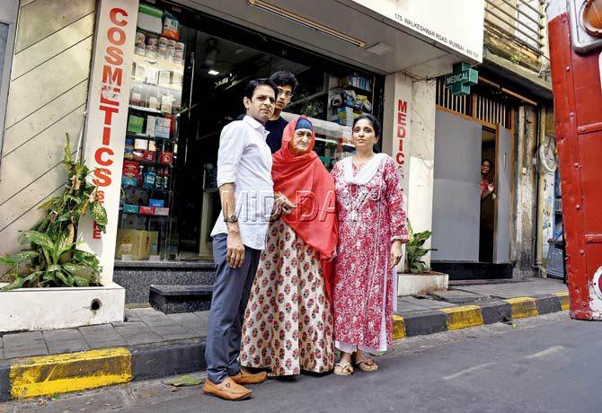Vikram Jain and his son Raj outside their pharmacy with their long-time neighbours in Navyug Chawl — 95-year-old Fatima Abdulrehman Vora and her daughter Nazma, who is Jackie Shroff