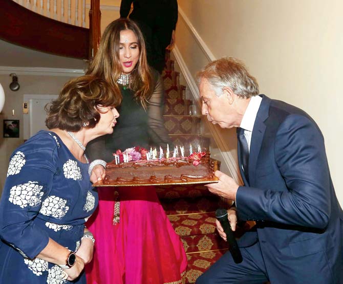 Tony Blair helps Cherie blow the candles. Pics/ Mohammed Jaffer-SnapsIndia