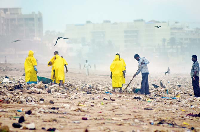 Clean-up crew at Versova beach covered in waste near Andheri West. Pic/Kaushik Thanekar