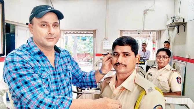 Zyros Zend with an officer at the Colaba police station