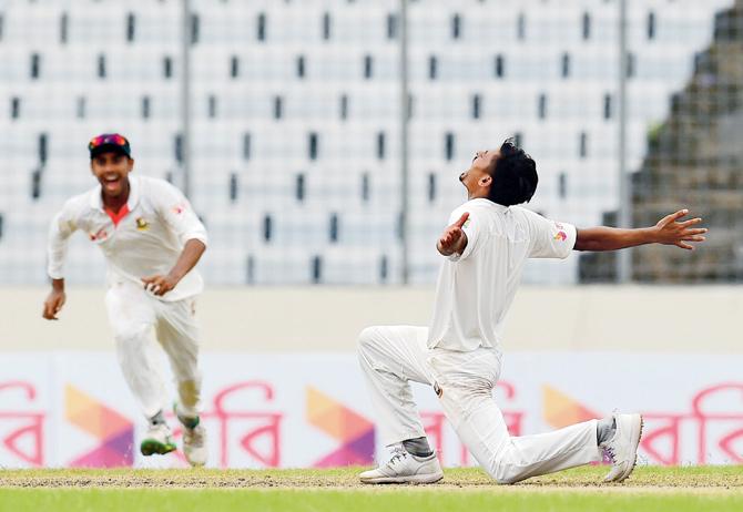 Bangladeshi cricketer Taijul Islam (right) reacts after dismissing Australia’s last man Josh Hazlewood at Dhaka on Wednesday. Pic/AFP