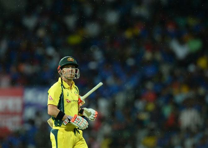 David Warner leaves the field after the first one day international (ODI) cricket match in the India-Australia series was suspended due to rain at the M A Chidhambaram stadium in Chennai