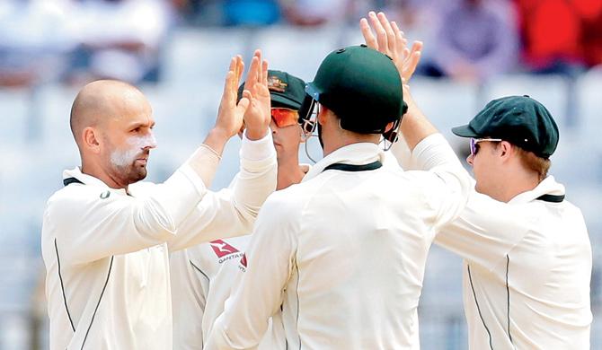 Australia spinner Nathan Lyon (left) celebrates a Bangladesh wicket with his teammates on Day Four  of the second Test at Chittagong yesterday. Australia won by seven wickets to level the series 1-1. Pic/PTI,AP