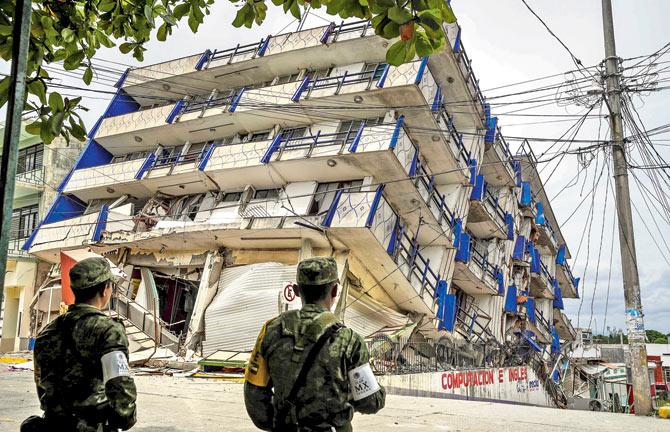 Soldiers stand guard near the Sensacion hotel, which collapsed with the powerful earthquake that struck Mexico. Pics/AFP