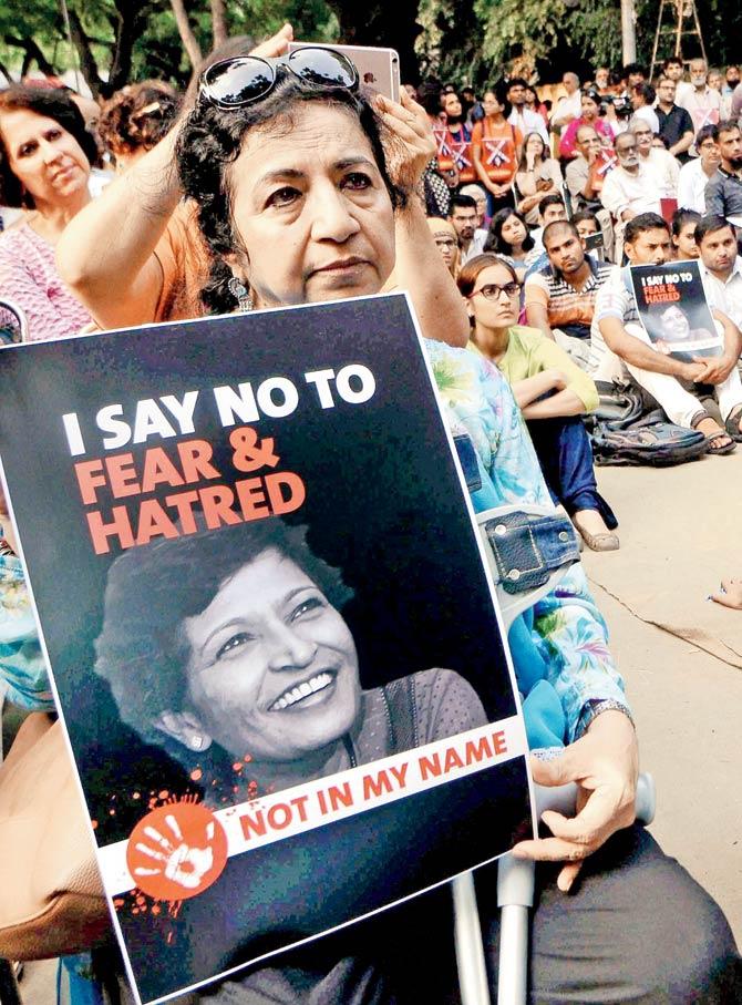 Demonstrators hold placards with the picture of journalist Gauri Lankesh in New Delhi on Thursday. Lankesh was shot dead on September 5. Pic/PTI