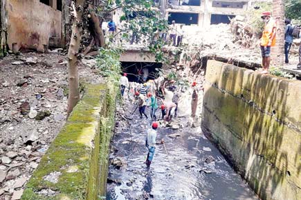 Thane family walks through flooded nullah to find missing son