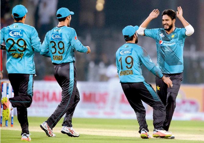Pakistani bowler Rumman Raees (extreme right) celebrates with teammates after dismissing World XI batsman Tamim Iqbal during the first T20 International at the Gaddafi Cricket Stadium in Lahore yesterday. Bangladeshi Tamim scored a run-a-ball 18. Pic/AFP