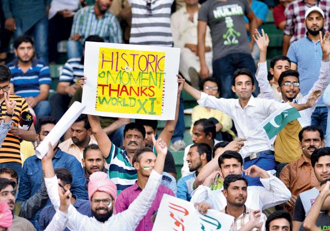A spectator cheers the Pakistan team yesterday. Pic/AFP