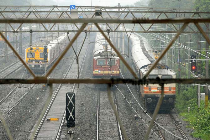  Trains ran slow during heavy rain showers in Mumbai on September 20, 2017. AFP PHOTO