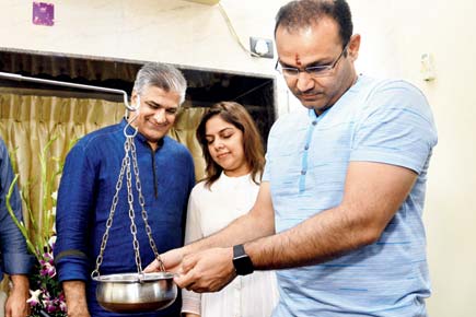 Mumbai: Virender Sehwag pours oil during wellness clinic inauguration