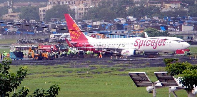 SpiceJet flight overshoots runway at Mumbai airport on Tuesday. Due to rains, gets stuck in mud. Pic/Nimesh Dave