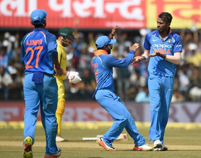Indian cricketer Hardik Pandya (R) celebrates with teammates after taking the wicket of Australian cricketer David Warner during the third one-day international cricket match between India and Australia at the Holkar Stadium in Indore on September 24, 2017. Pic/AFP