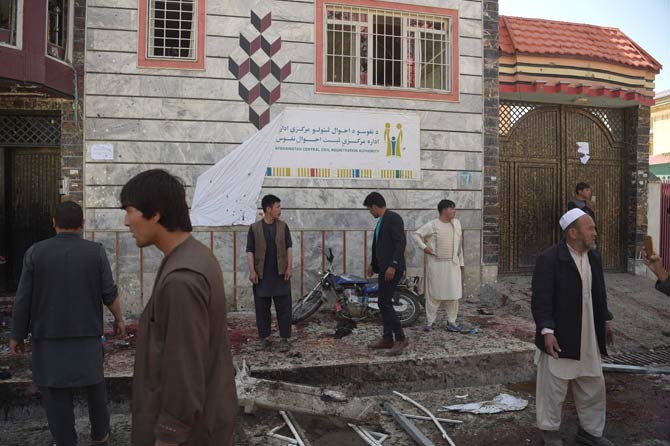 Afghan residents inspect the site of a suicide bombing outside a voter registration centre in Kabul. Pic/AFP