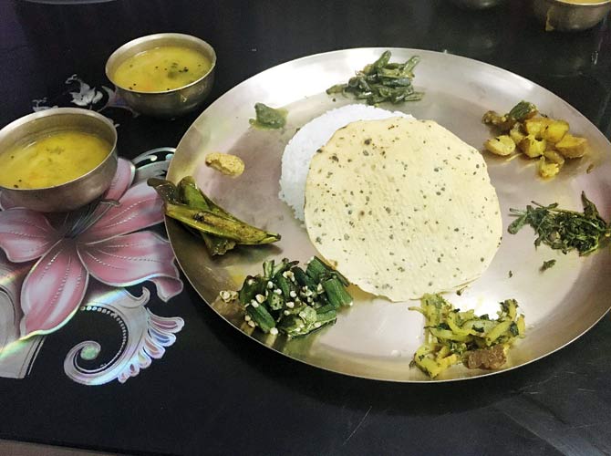 A platter with boiled taro greens and other veggies