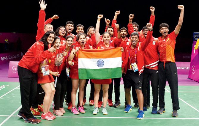 Indian badminton team pose with the tri-colour after winning the mixed team gold in Gold Coast, Australia yesterday. Pic/PTI