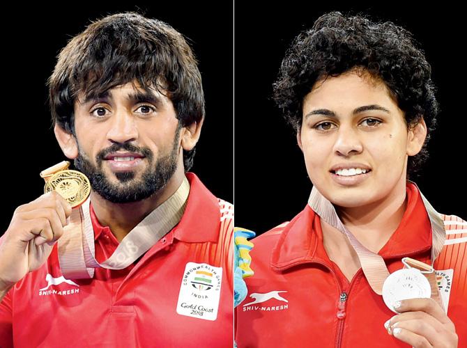Wrestler Bajrang with gold medal and Pooja Dhanda with her silver