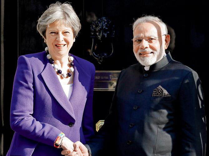 UK Prime Minister Theresa May greets PM Narendra Modi as he arrives at 10 Downing Street in London on Wednesday. Pic/AFP