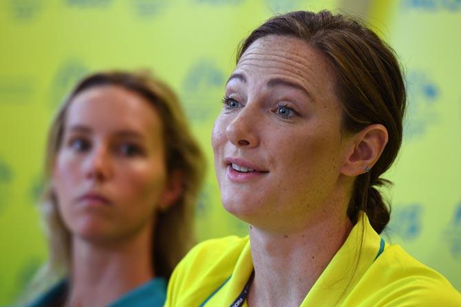 Australian swimmer Cate Campbell (R) speaks as teammate Emma McKeon (L) listens during a press conference ahead of the 2018 Gold Coast Commonwealth Games, on the Gold Coast on April 1, 2018. / AFP