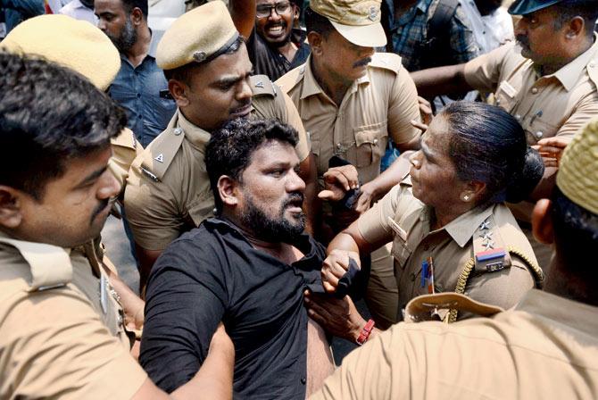 Cops detain a member of a Tamil ethnic group during a protest against the govt’s delay in implementation of a water management board. Pic/AFP