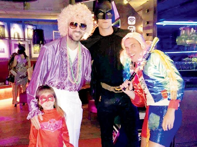 Cesc Fabregas with daughter (in red) and  teammates Pedro (right) and Marcos Alonso, as Batman