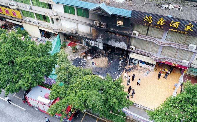 Police in the southern Chinese city have caught a man suspected of setting the fire at the three-story building. Pic/AP