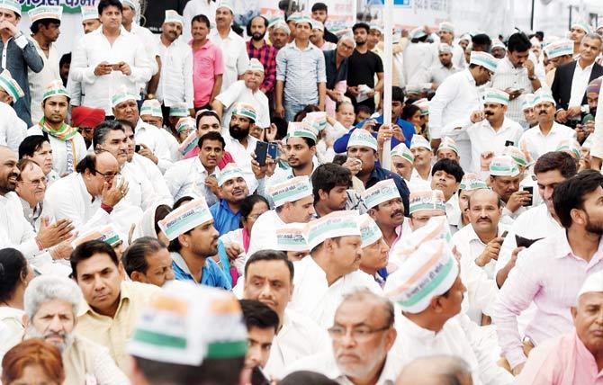 Congress party supporters gather outside Raj Ghat, the memorial of Mahatma Gandhi, in New Delhi, on Monday. PIC/AFP