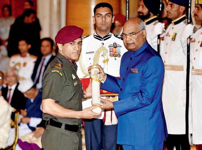 President of India Ram Nath Kovind presents the Padma Bhushan to Mahendra Singh Dhoni in New Delhi yesterday. Pic/AFP