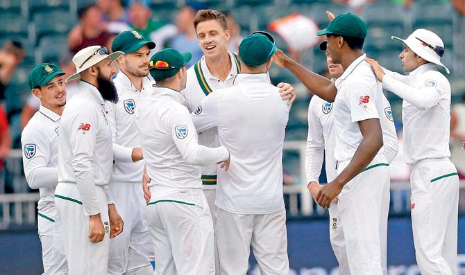 SA pacer Morne Morkel (centre) celebrates the wicket of Australia opener Joe Burns yesterday