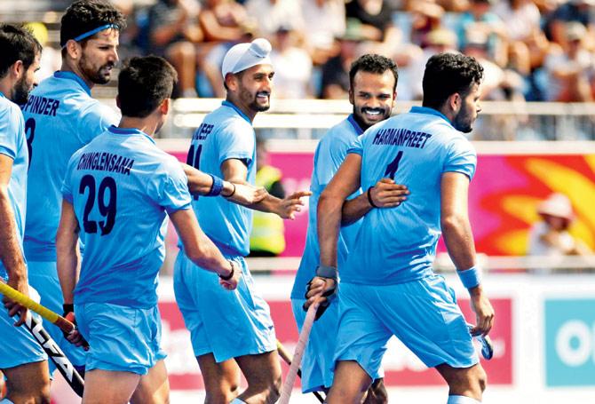 Harmanpreet Singh (right) celebrates after scoring the opening goal against Malaysia at Gold Coast, Australia yesterday. Pic/AFP