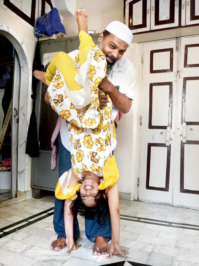 Faizan Kapadia, a garage owner, helps daughter Hazequa into a headstand. Pic/Sneha Kharabe