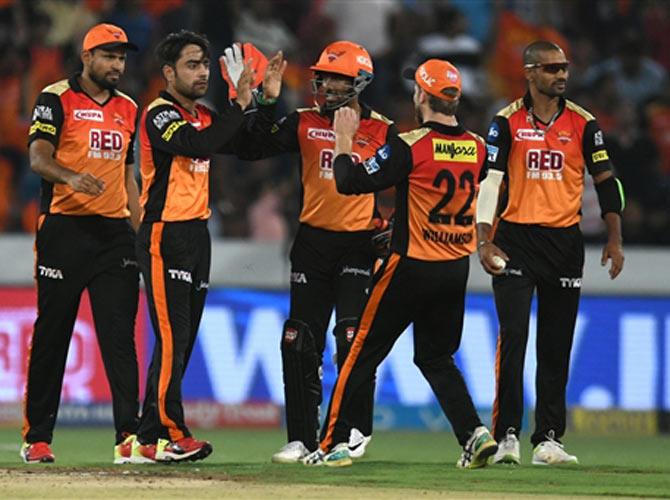 Hyderabad cricketer Rashid Khan (2L) celebrates with teammates after taking the wicket of Punjab cricketer Karun Nair (unseen) during the T20 2018 match between Hyderabad and Punjab/ AFP