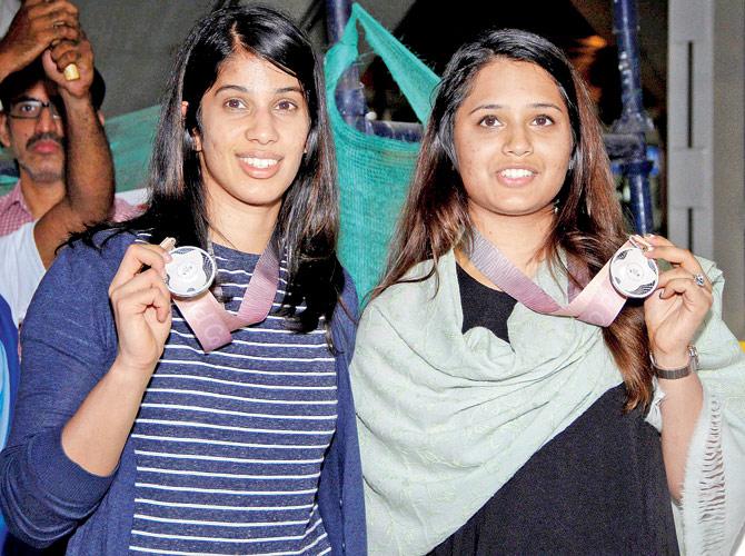 India squash stars Joshna Chinappa (left) and Dipika Pallikal with their CWG silver medals at Chennai airport on Monday. Pic/PTI