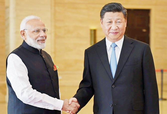 Prime Minister Narendra Modi shakes hands with Chinese President Xi Jinping during their meeting, in Wuhan, China, on Friday. Pic/PTI