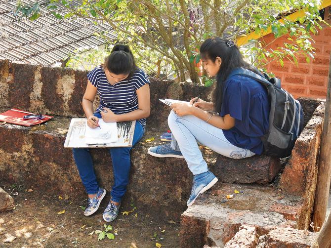 Participants take in the scenery at an art tour of Sindhudurg