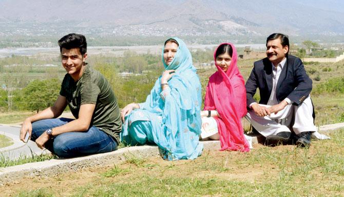 Malala Yousafzai (second from right), with her family at the all-boys Swat Cadet College Guli Bagh. Pic/AFP
