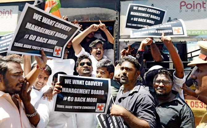 Protesters shout slogans against PM Narendra Modi. Pics/pti