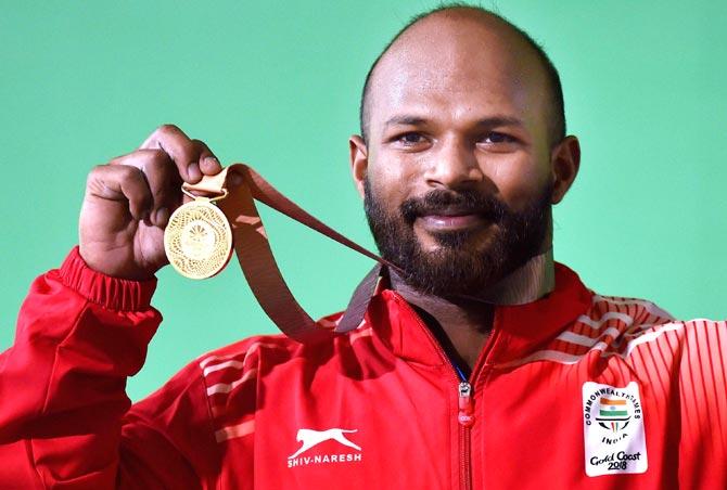 Gold medalist Indian Weightlifter Sathish Kumar Sivalingam during the medal ceremony of the men