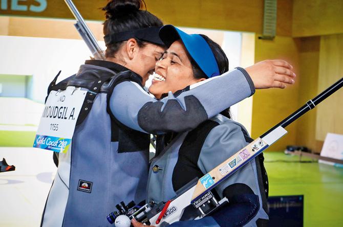 Tejaswini Sawant and Anjum Moudgil (left) hug each other after winning gold and silver respectively. Pic/AFP