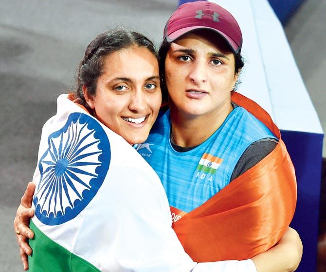 Silver medallist Seema Punia (right) and bronze-winner Navjeet Dhillon celebrate their success in Gold Coast yesterday. Pic/PTI