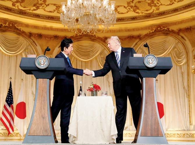Shinzo Abe (left) with Donald Trump. Pics/AP and AFP