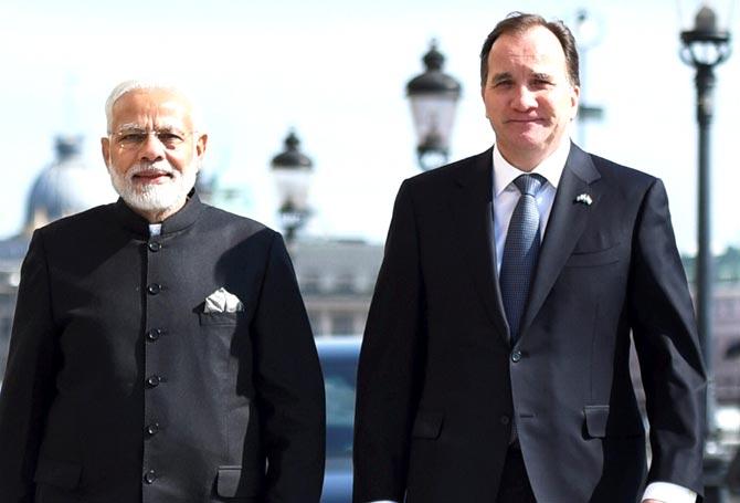 Prime Minister Narendra Modi takes a short walk with the Prime Minister of Sweden, Stefan Lofven from Sager House to Rosenbad, in Stockholm. Pic/PTI