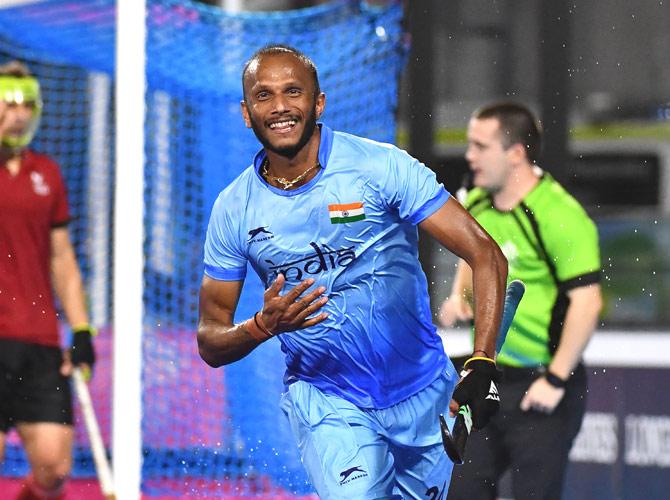 Sunil Sowmarpet (C) of India celebrates scoring a goal during the men