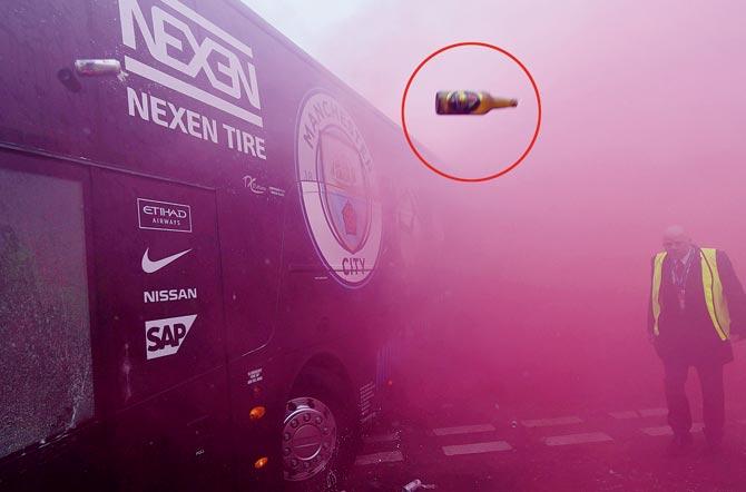 A missile (encircled) is thrown at the Man City team bus as it arrives for their Champions League clash v Liverpool on Wednesday. Pic/AFP