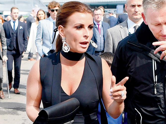 Coleen Rooney arrives at Aintree Racecourse in Liverpool on Saturday. Pic/AFP