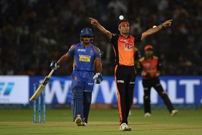 Hyderabad cricketer Siddarth Kaul (R) celebrates the wicket of Rajasthan