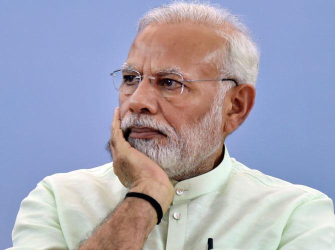 PM Narendra Modi presents pair of slippers to tribal woman in Chhattisgarh